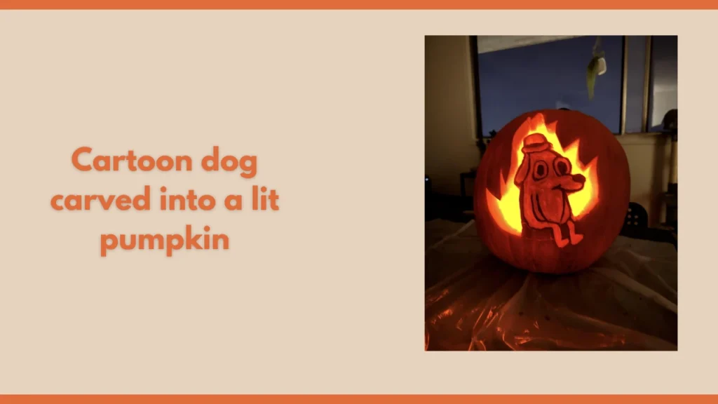 Cartoon dog carved into a lit pumpkin