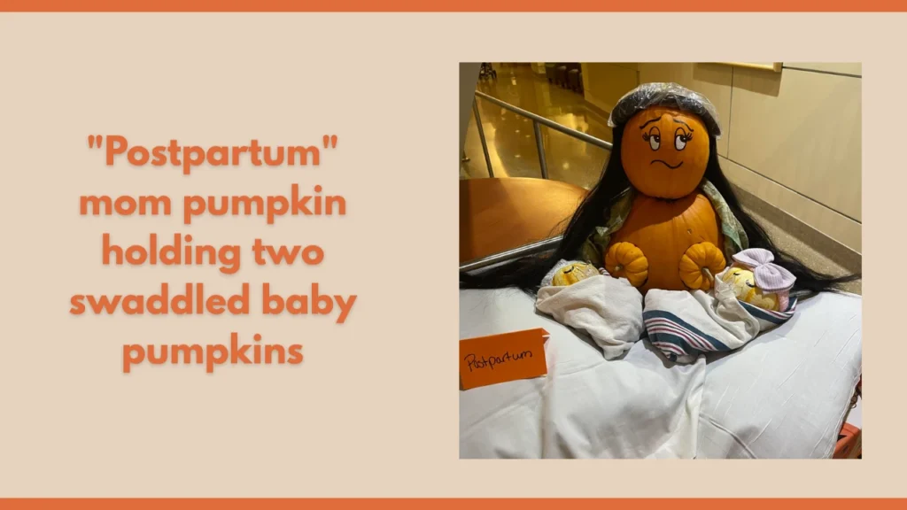"Postpartum" mom pumpkin holding two swaddled baby pumpkins