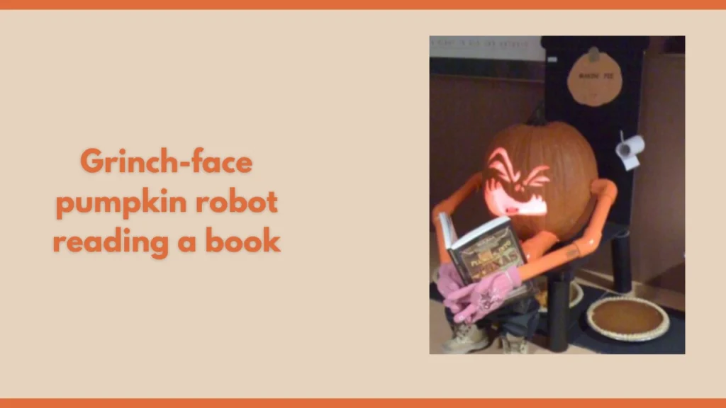 Grinch-face pumpkin robot reading a book
